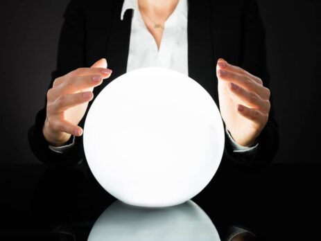 Business woman gazing at a crystal ball | MD Communications