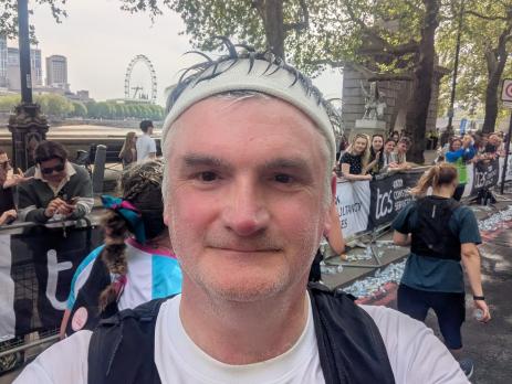 Law Society President Mark Evans taking a selfie at the end of the London Marathon. He is wearing a headband, and rucksack, and a t-shirt with the LawCare logo